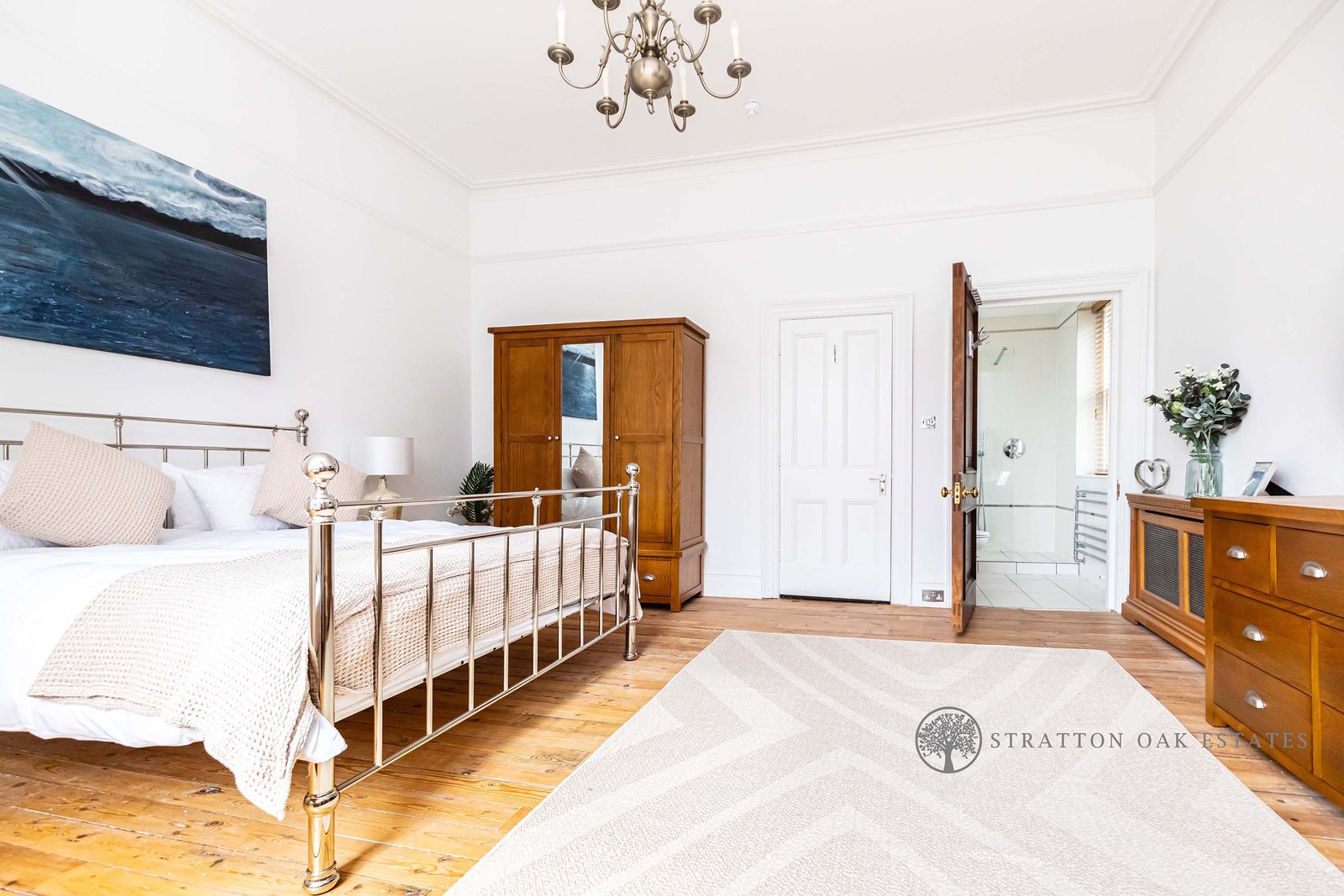 Bedroom with brass bed and ensuite